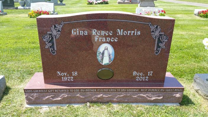Serpentine top monument with custom inlaid color etched tile and covered porcelain photo.